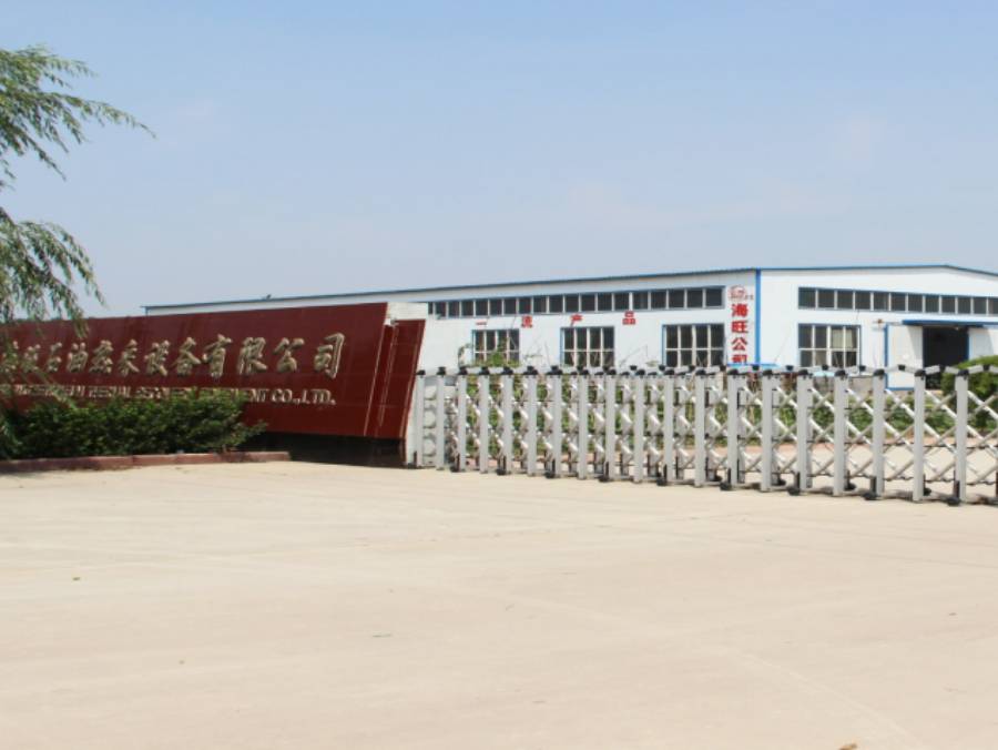 Photo of company gate and a willow is on beside of the gate.