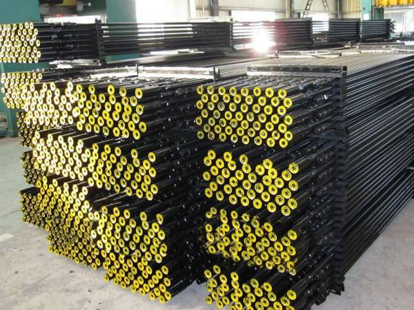 Several bundle sucker rod packaged by the angle steel and bolts are placed on the ground.