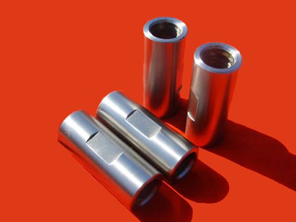 Four sucker rod couplings with wrench square on the coupling body.